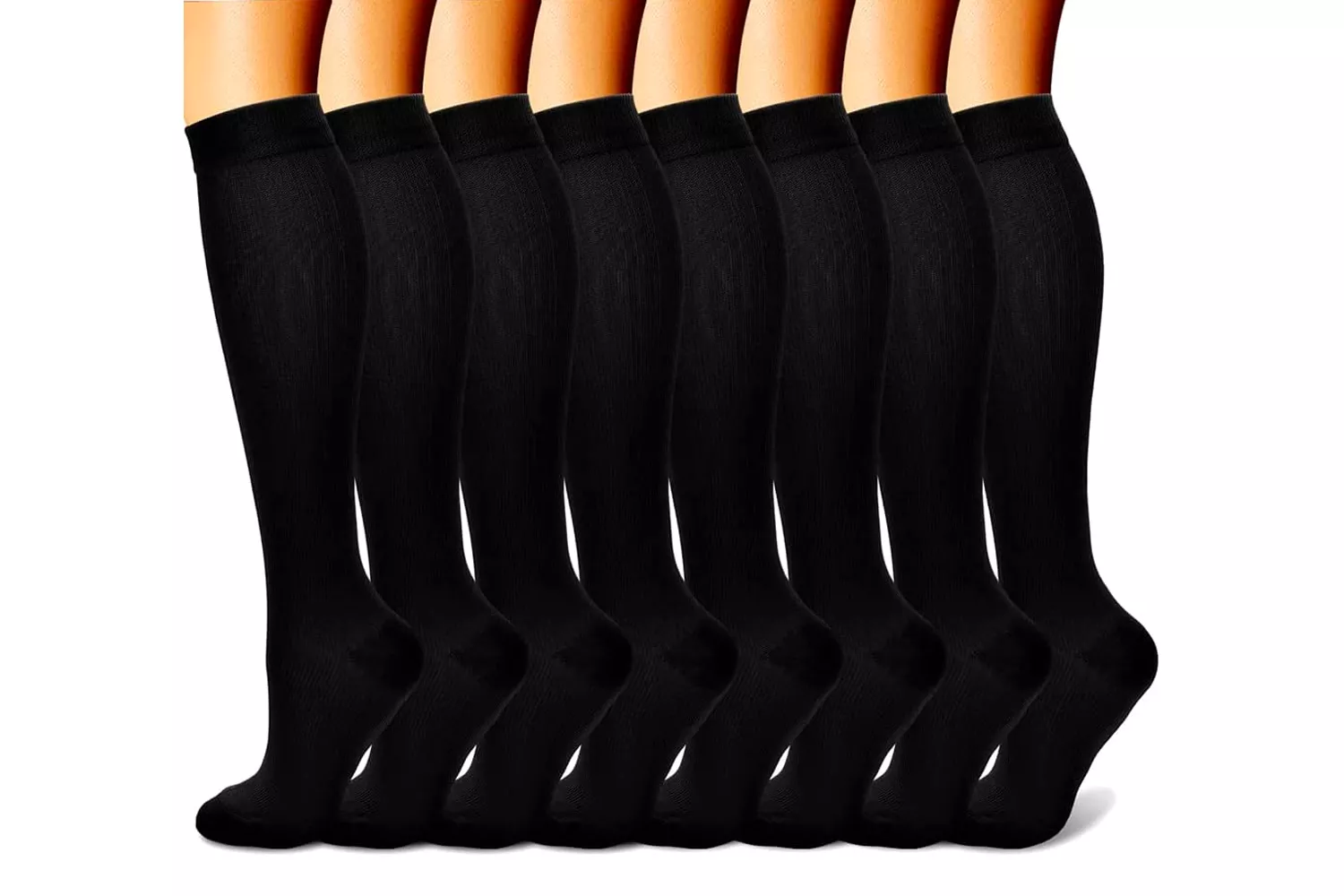 A row of several legs wearing black knee-high compression socks highlighting uniform support.