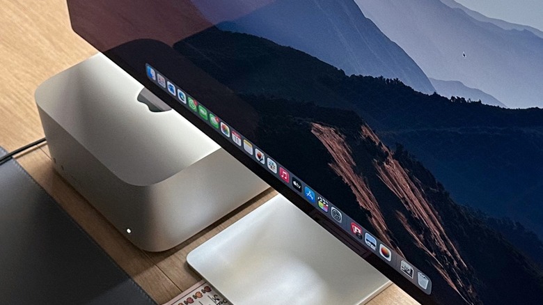 An Apple Studio Display monitor paired with a Mac Studio on a modern office desk.