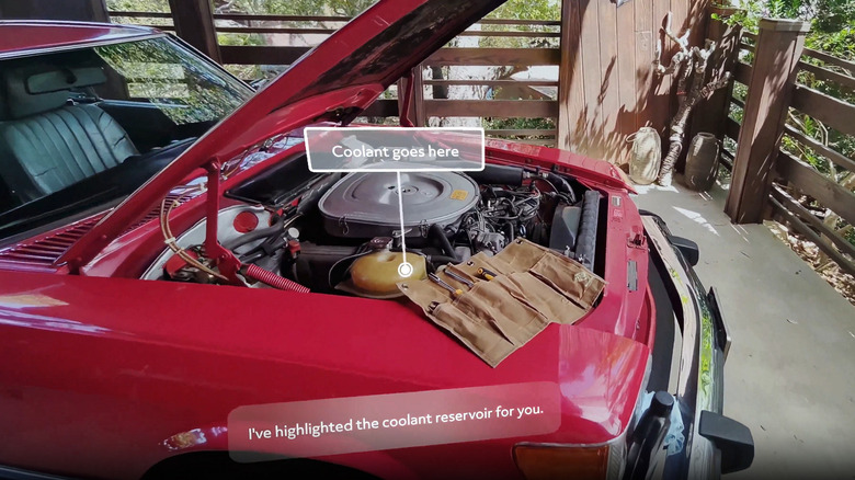 Augmented reality interface highlighting specific components under a car's hood to assist with maintenance.