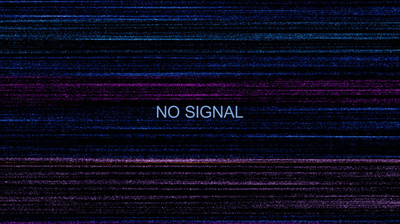 A close up of a monitor screen displaying a standard 'No Signal' notification text box.