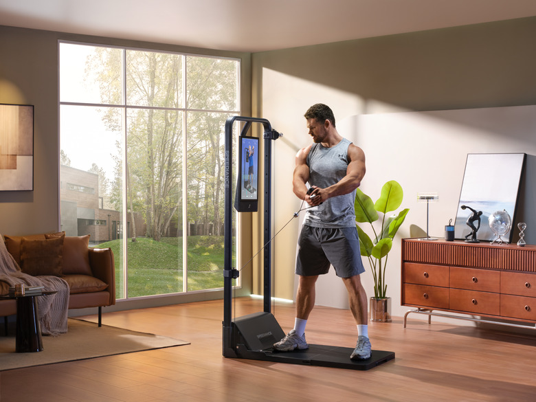 The Speediance Gym Monster 2 set up with various handle and barbell accessories.