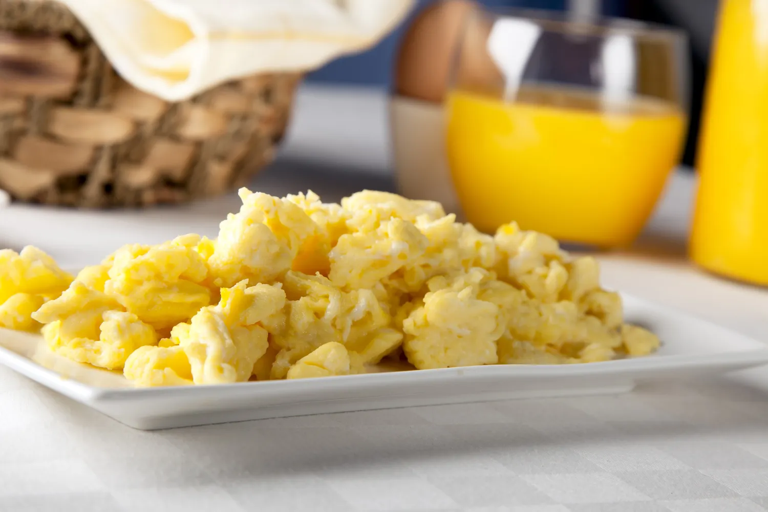 A plate of fluffy, yellow scrambled eggs.