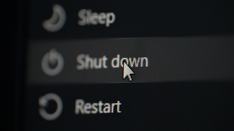 Close-up of clicking the shut down option on a Windows computer to initiate a hybrid boot state.