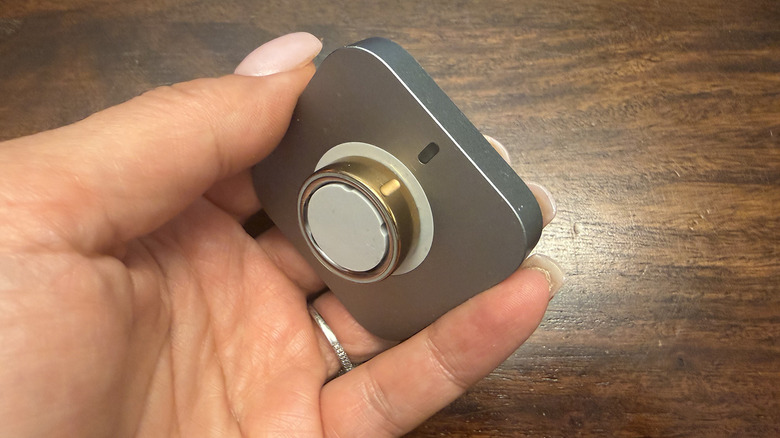 The Oura Ring 4 sitting on its dedicated circular charging dock.
