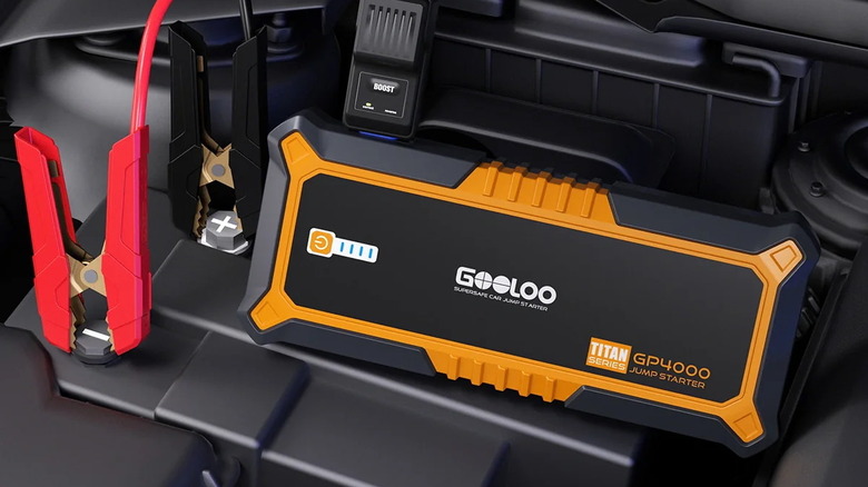 GOOLOO GP4000 high-capacity jump starter connected to a large engine battery.