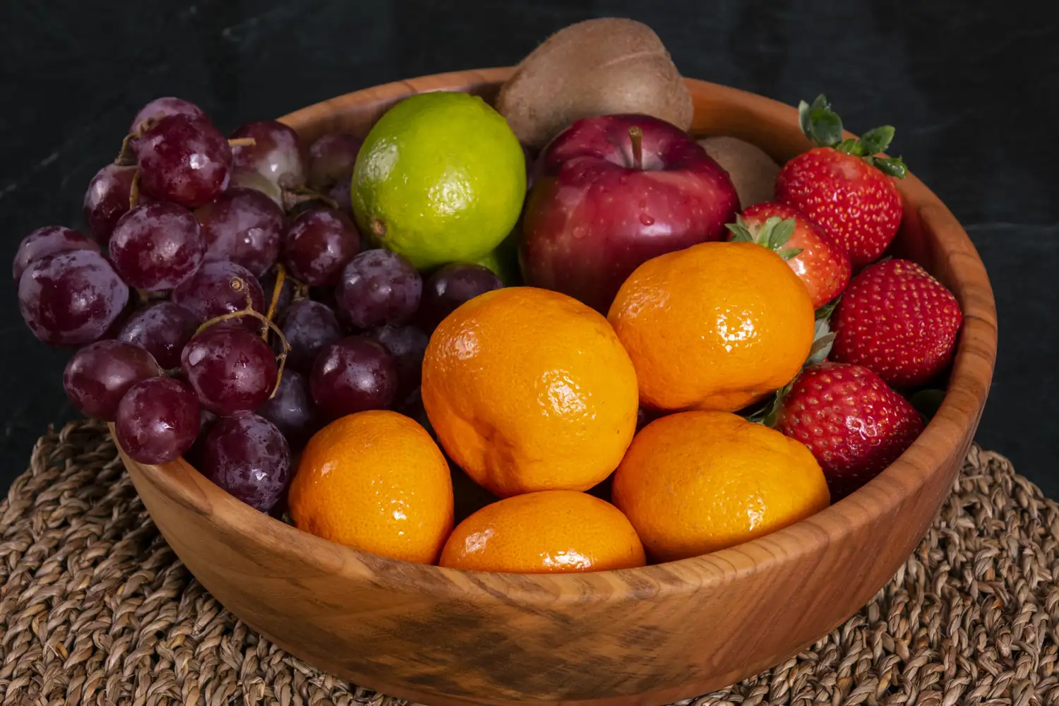 An assortment of fresh sliced fruits including berries and citrus.