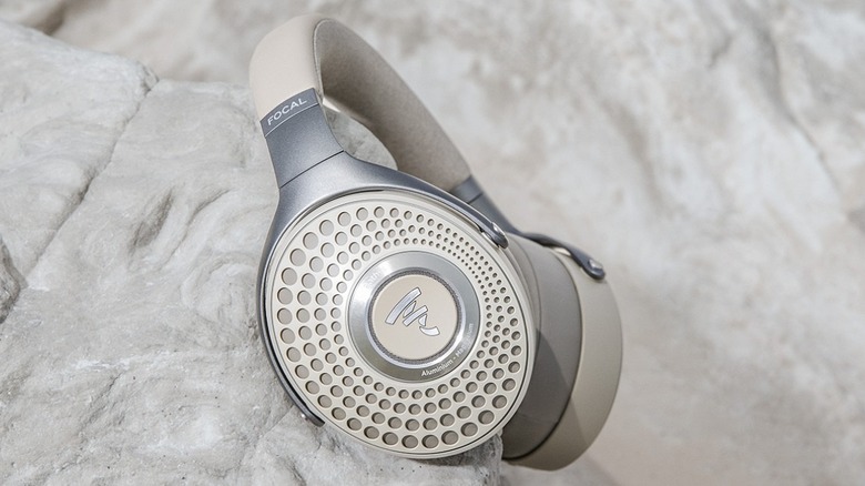 Focal Bathys high-end wireless headphones resting on a stone surface.