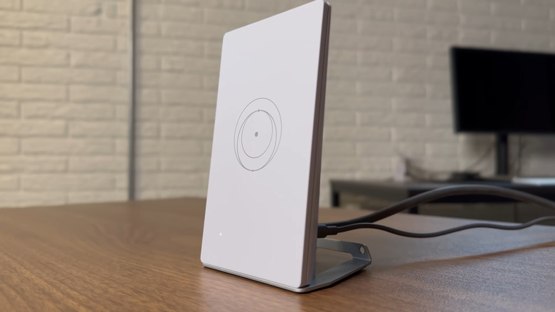 Starlink Router Mini sitting on a table with cables connected.