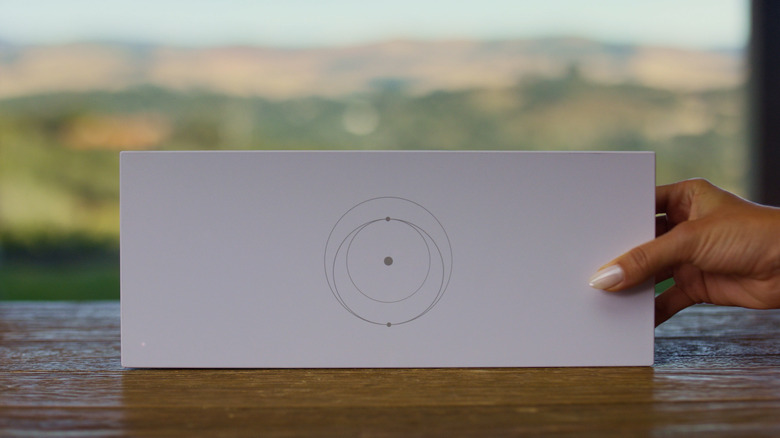 A person holding the large white Starlink Gen 3 Router.