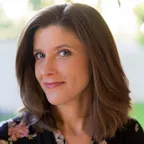 A smiling woman in a bright setting representing mental well-being and vitality.