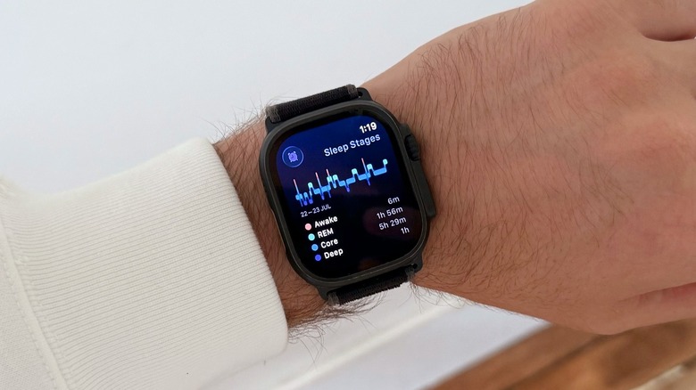 A man's wrist featuring an Apple Watch Ultra showcasing the Sleep Stages tracking interface with detailed metrics.