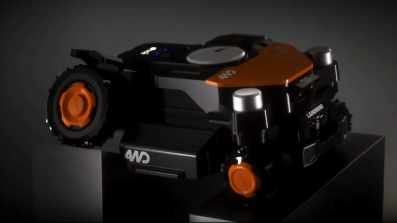 A Worx Landroid Vision Cloud robot mower displayed on a white exhibition pedestal.