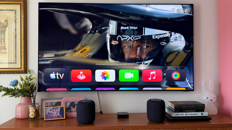 Apple TV 4K displayed on a Samsung TV alongside two HomePod 2nd generation speakers in a living room setup.