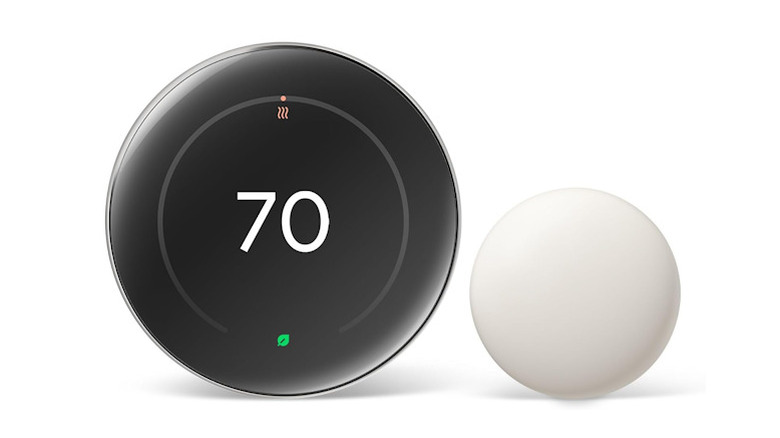 Google Nest Learning Thermostat featuring a polished metal finish with its small white remote sensor.