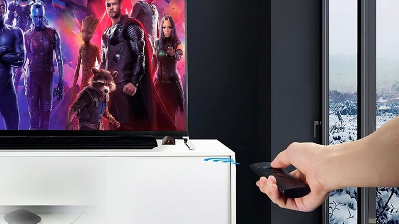 The small Herfair IR receiver eye mounted discreetly near a television in a living room.