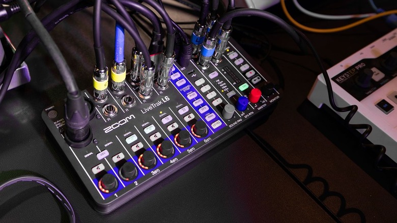 The Zoom LiveTrak L-6 mixer with several audio cables connected, highlighting its compact multitrack capabilities.
