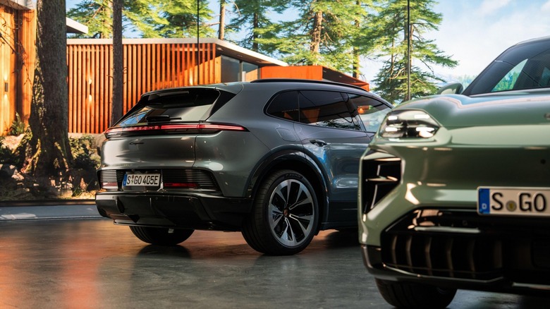 Front and rear views of silver Porsche Cayenne EVs parked in a slate driveway.