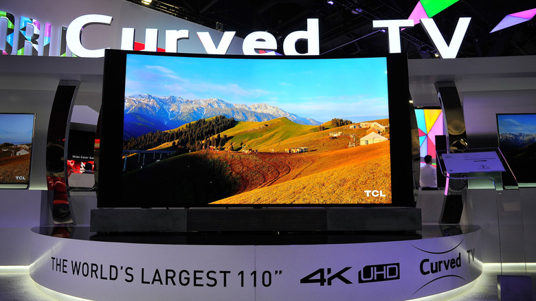 A massive 110-inch curved TV being exhibited at a consumer electronics show.